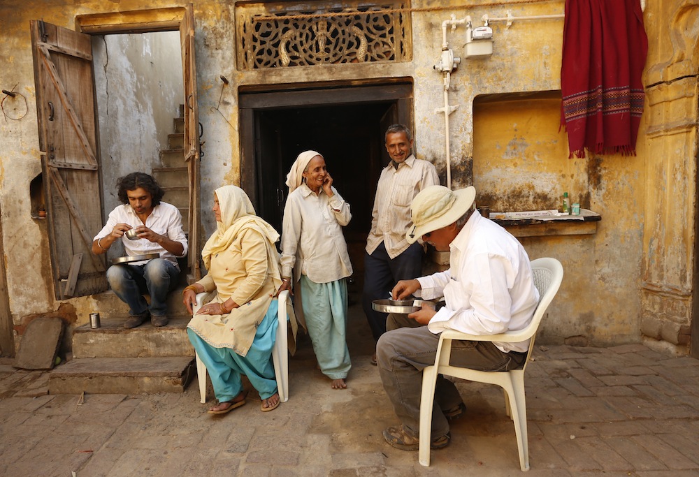 Imtiaz Ali and Anil Mehta (DoP) enjoy a simple meal cooked by the residents of the house they were shooting in for HIGHWAY, Village Dayalpur-Haryana