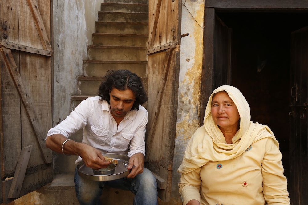 Imtiaz Ali enjoys a simple meal cooked by the resident of the house he was shooting in for HIGHWAY, Village Dayalpur-Haryana