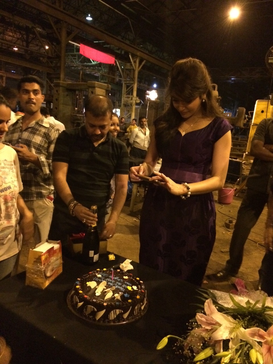 Anushka taking a picture of the cake before cutting it